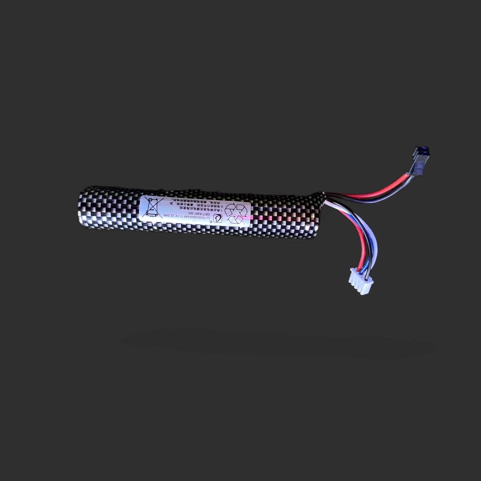 A BlasterMaster 11.1V 18350 2000mAh SM2 30C long skin battery isolated on a gray background, featuring a wrapped cell and connected wires with plastic connectors.