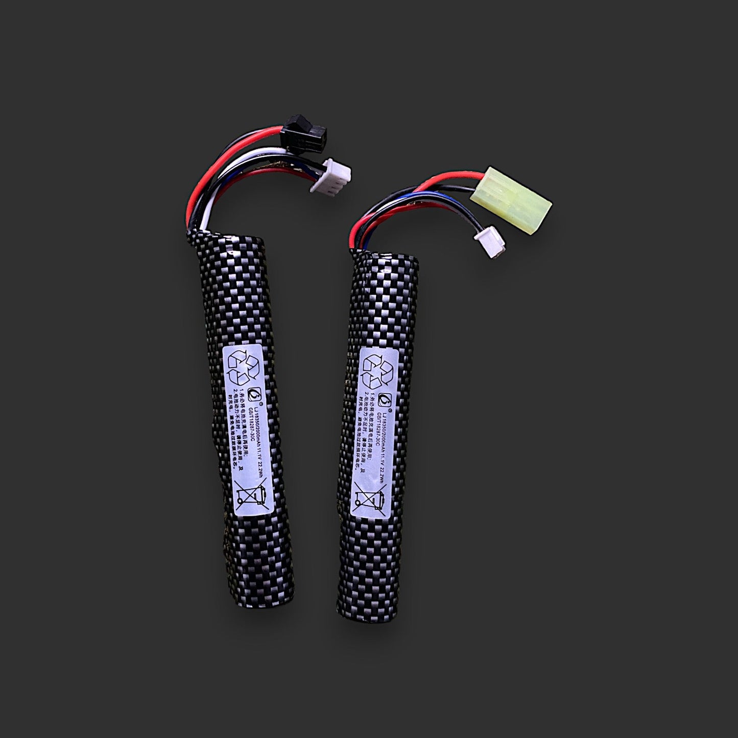 Two BlasterMaster cylindrical 11.1V 2000mAh lithium-ion batteries with carbon fiber patterns and connected wires, isolated on a gray background.