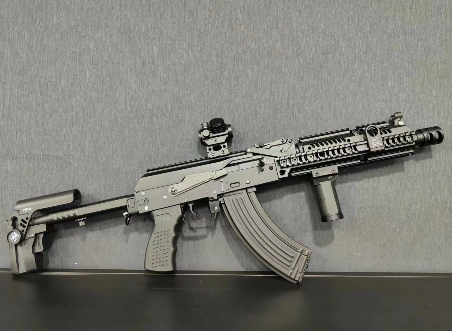 A highly detailed model of a BlasterMaster PP19 Vityaz submachine blaster with scope, mounted on a grey background.