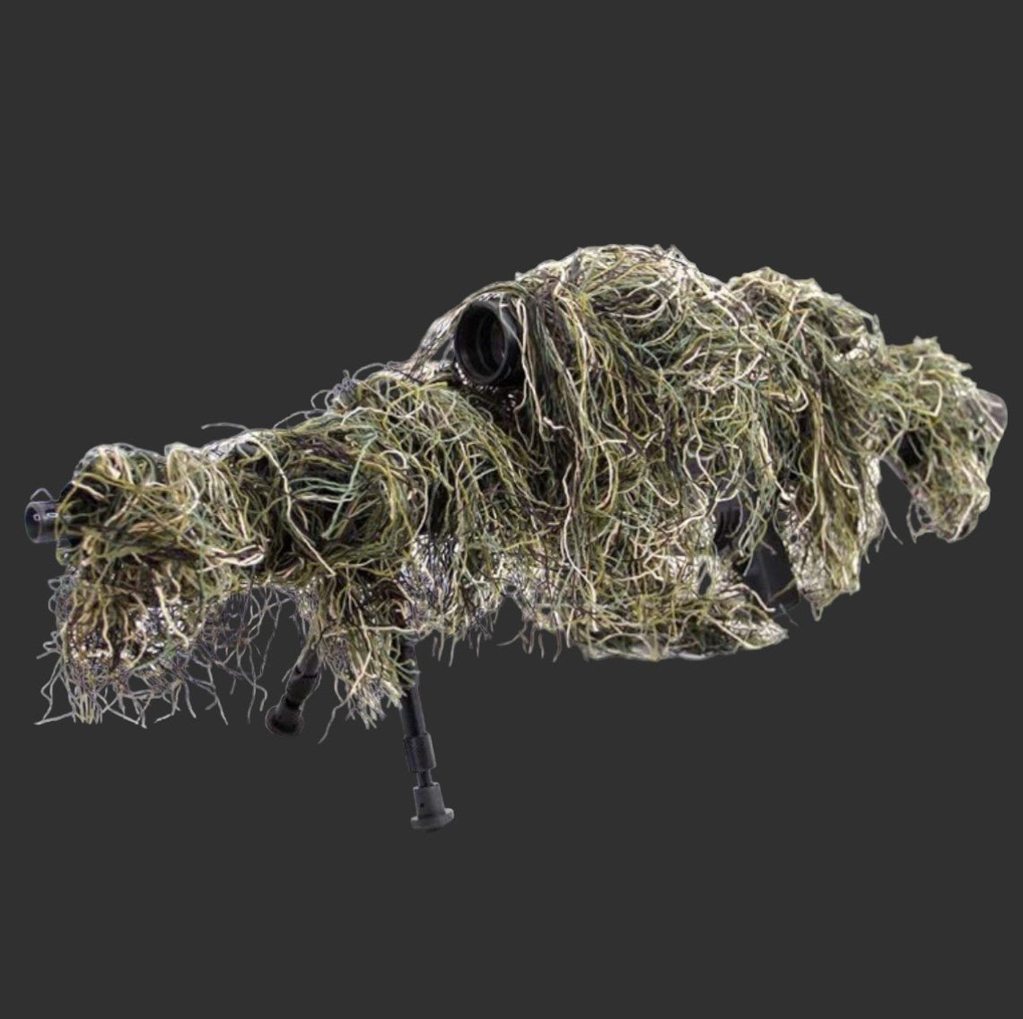 A covered sniper rifle with extensive camouflage netting and grass provides firearm protection, concealing its shape and features against a dark gray background with the StealthGuard Gun Cover by BlasterMasters.